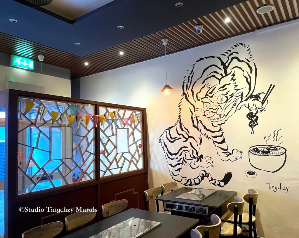 Tiger figure with ink painting in asian restaurant