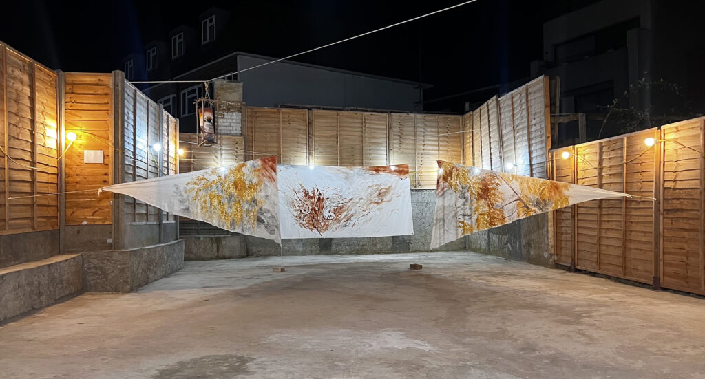 Installation view of Travelers, suspended paintings exploring atmospheric space and East Asian spatial traditions.
